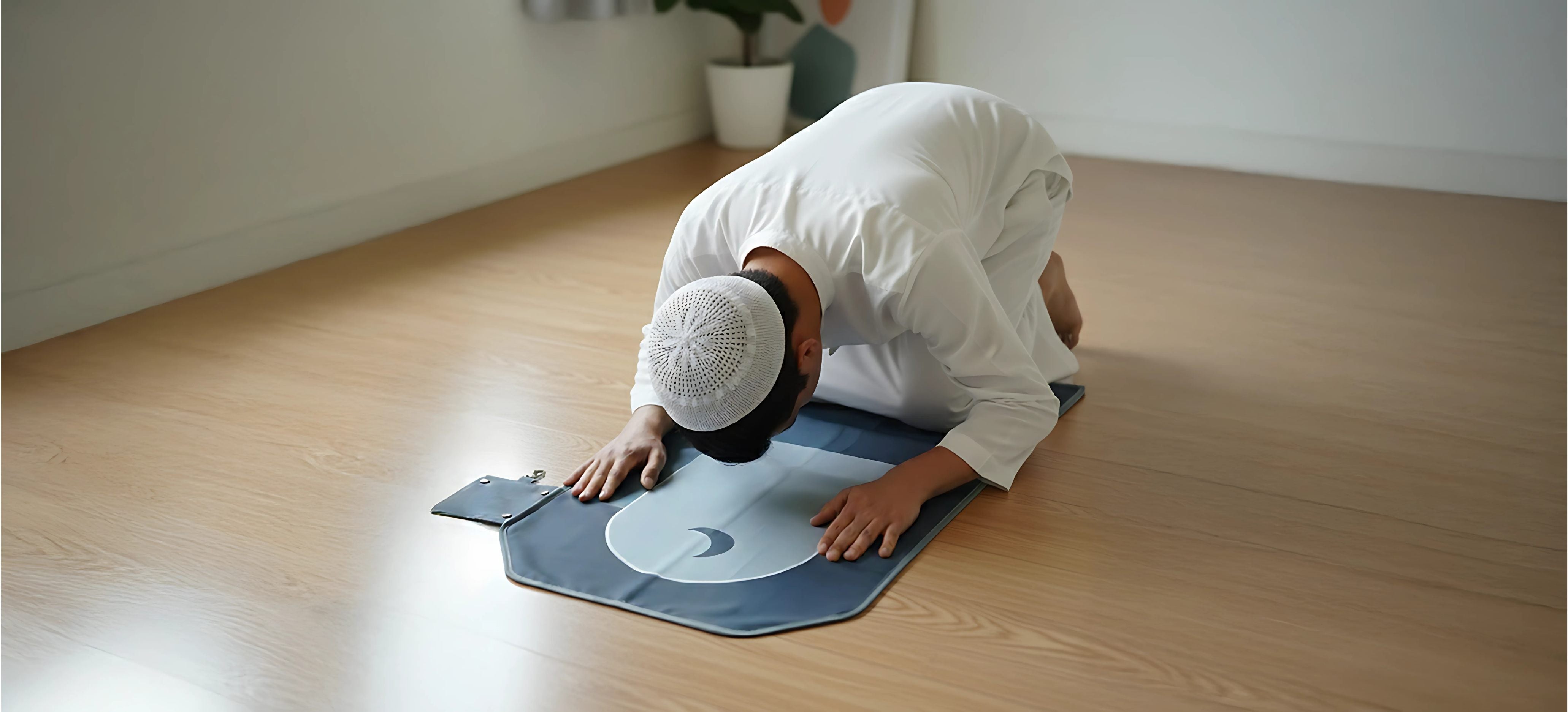 Muslim man praying on a SalahTag prayer mat indoors in a room