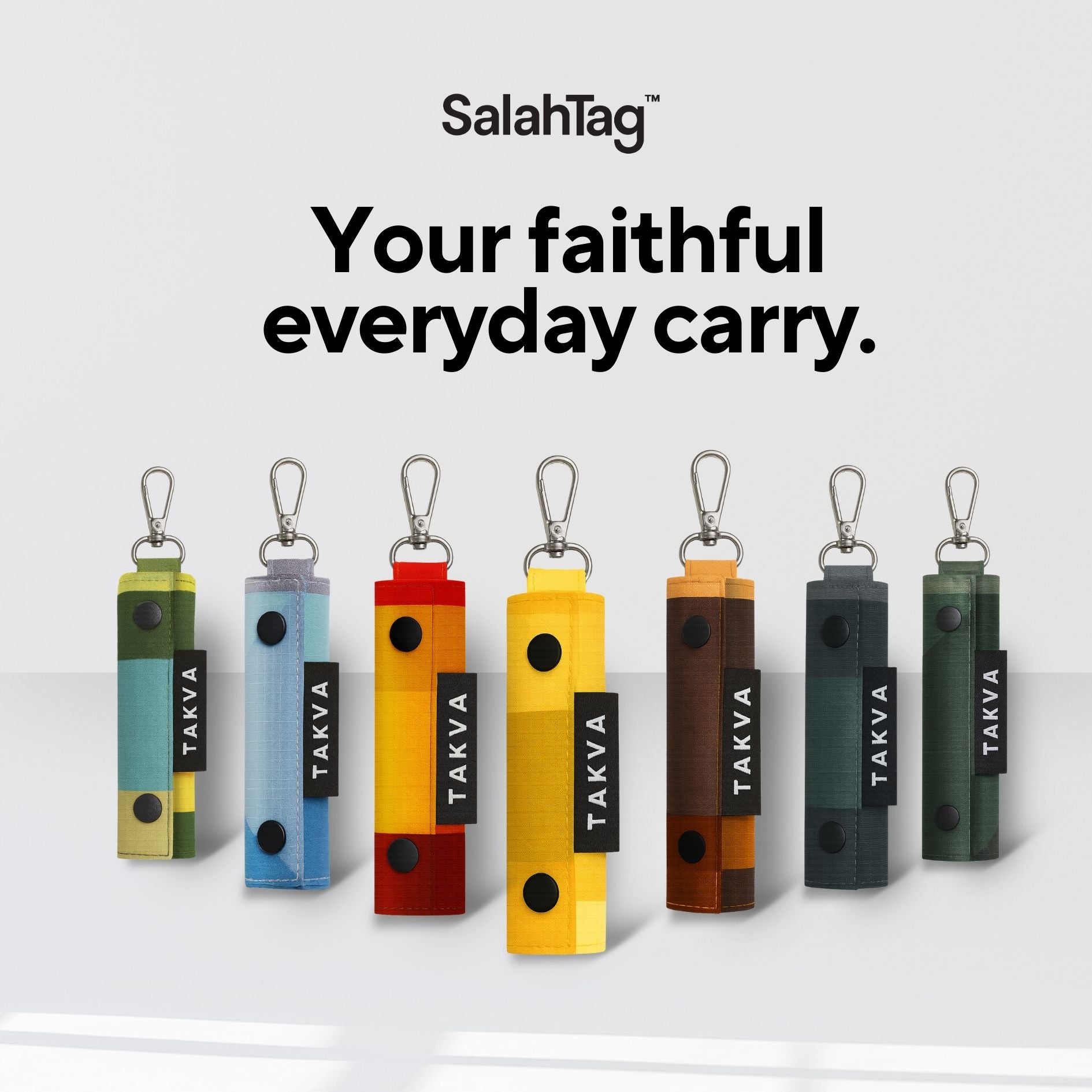 Seven SalahTag portable prayer mats in different colors with carabiner clips displayed in a row