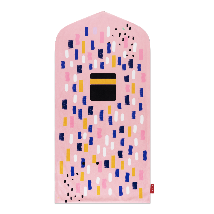Image of the prayer mat on a wall: "Pink prayer mat for kids - a removable and washable Islamic home decor item that doubles as wall art."