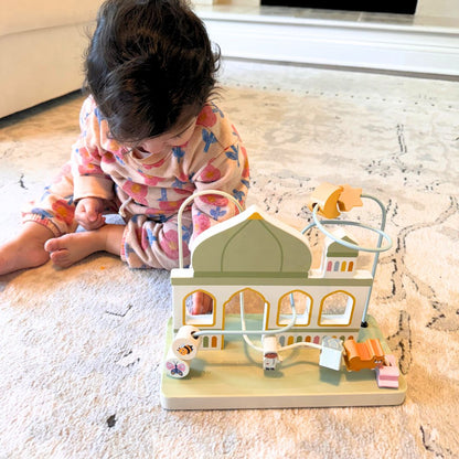Toddler playing with Montessori masjid bead maze toy