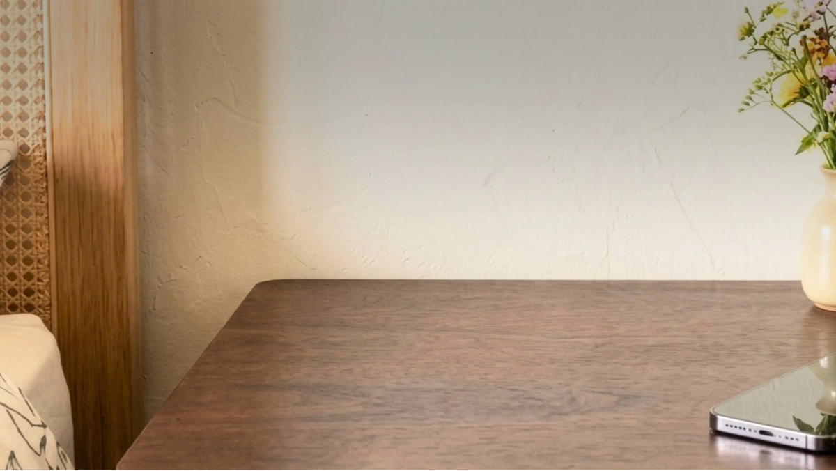 Calm bedside table by a plaster wall, showing Islamic bedroom decor ideas for keeping a TAKVA Mini close at night