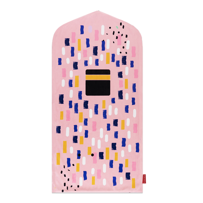 Image of the prayer mat on a wall: "Pink prayer mat for kids - a removable and washable Islamic home decor item that doubles as wall art."