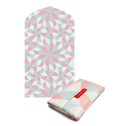 Image of the pink prayer mat being unfolded and spread out on the ground: "Waterproof prayer mat - our prayer rug is made from durable and waterproof materials, making it ideal for use in any weather conditions."