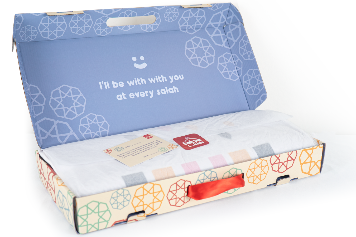 Image of the prayer mat rolled up and stored in a box: "Prayer mat gift set - our removable and washable prayer mat for children comes with a storage box for easy transport.
