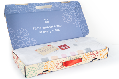 Image of the prayer mat rolled up and stored in a box: "Prayer mat gift set - our removable and washable prayer mat for children comes with a storage box for easy transport.